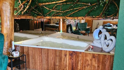 a large bath tub sitting inside of a house at Siedlisko Bogdanka in Leszczewek