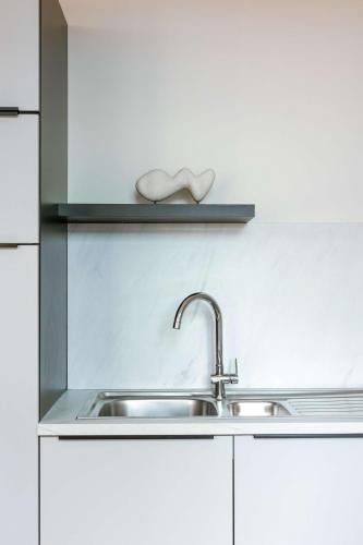 a kitchen with a sink and a shelf at Apartment near Antwerp Cathedral in Antwerp