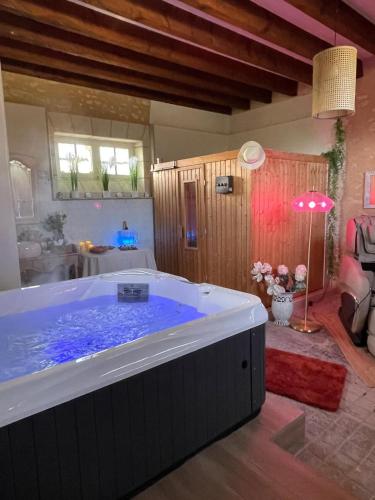a large bath tub in a room with at Studio Charmant au Château Leugny in La Celle-sous-Gouzon