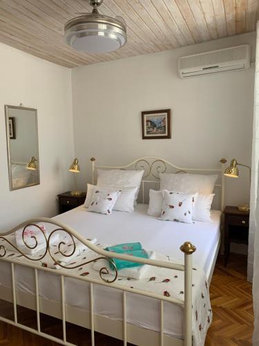 a bedroom with a white bed with white sheets and pillows at Goga in Selce