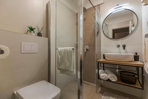 a bathroom with a sink and a mirror at Apartments Agava in Rabac