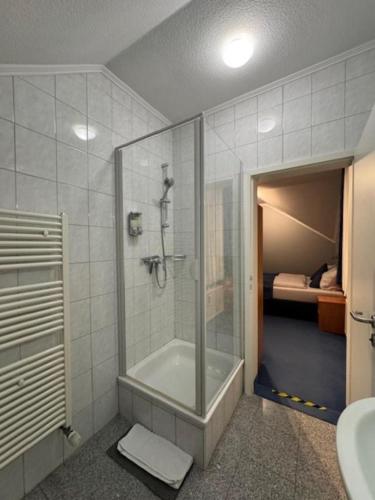 a bathroom with a shower and a toilet and a sink at Nassauer Hof Wiesbaden-Schierstein in Wiesbaden