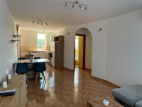 a living room with a couch and a table at Hársfa Central Apartment in Mórahalom