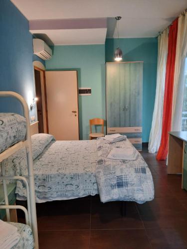 a bedroom with two beds and a table in it at Hotel Mirage in Rimini