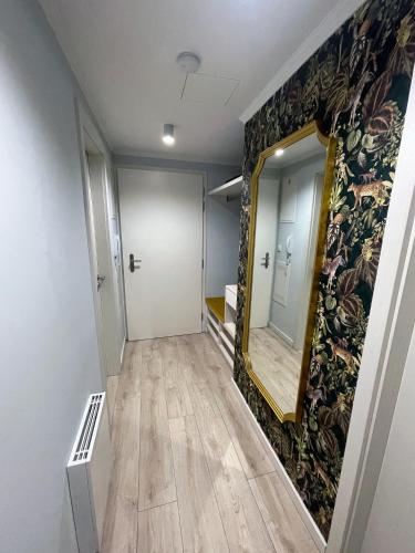 a hallway with a mirror on a wall at Kora Apartments in Prague