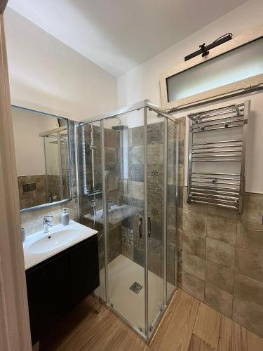 a bathroom with a sink and a shower at Antico Pozzo in Badia