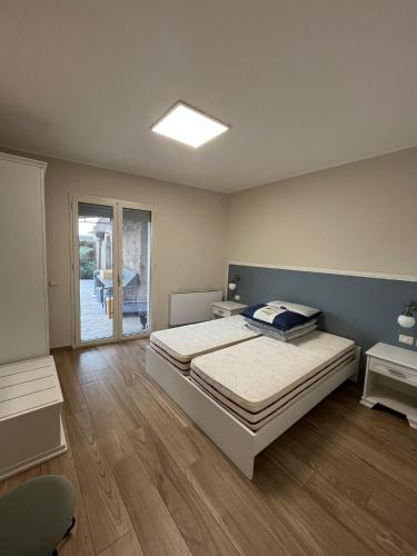 a bedroom with a bed and a sliding glass door at Antico Pozzo in Badia