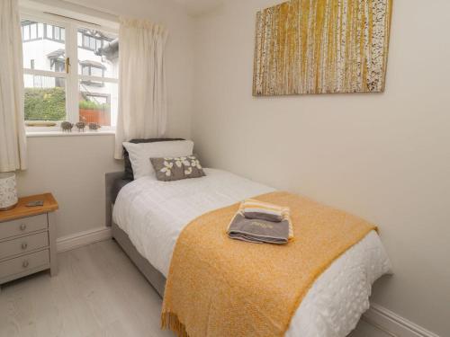a bedroom with a bed with a suitcase on it at Castle View in Deganwy