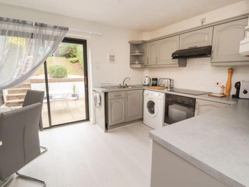 a kitchen with a sink and a dishwasher at Castle View in Deganwy