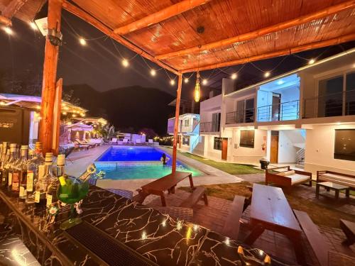 a bar in front of a house with a swimming pool at MAR y LAGO EXPERIENCE in Lunahuaná