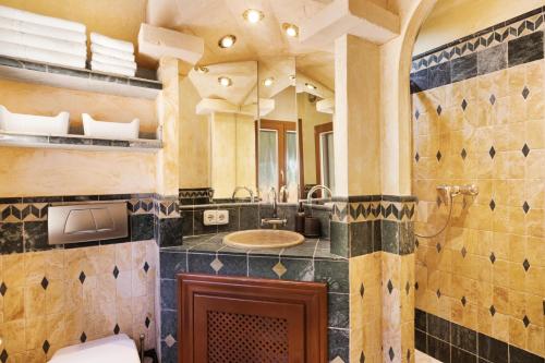 a bathroom with a sink and a large mirror at Villa Sophia in Port d'Andratx