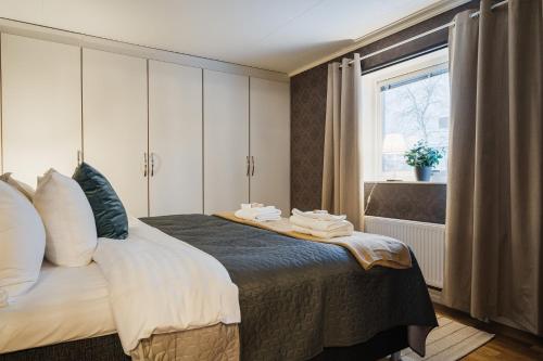 a bedroom with a bed with towels on it at Guestly Homes - Spacious Top Floor 2BR Residence in Luleå