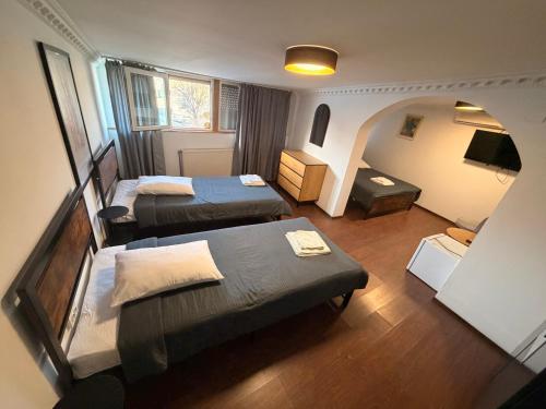 a small room with two beds and a room with at Pensiunea Luisa in Craiova