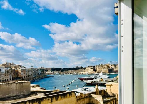 a view of a harbor with boats in the water at Turretta Stay - Private Room with Ensuite Bathroom in Vittoriosa, Three Cities in Birgu