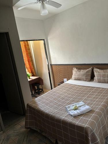 a bedroom with a bed with a towel on it at Condo Flat Solar de Aquários in Cabo Frio