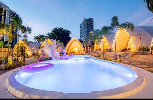 a large swimming pool in the middle of a city at kingdom glamping in North Pattaya