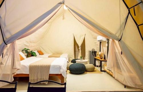 a bedroom with two beds in a tent at kingdom glamping in North Pattaya