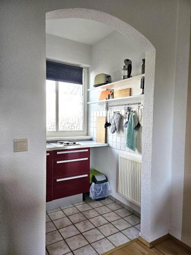 a kitchen with an archway leading into a small kitchen at Seepavillon Rheinsberg in Rheinsberg