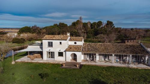 an aerial view of a white house at Mas du Couvin, maison d'hôtes en Camargue in Saintes-Maries-de-la-Mer
