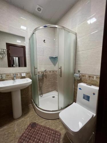 a bathroom with a shower and a toilet and a sink at Amina in Samarkand