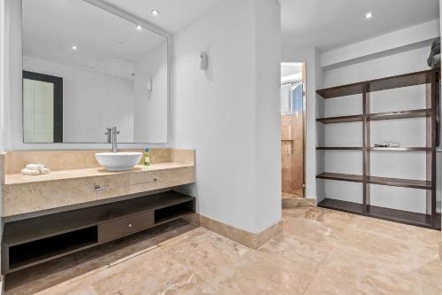 a bathroom with a sink and a mirror at Deck12 Casino and Resort by Monyxbnb in Puerto Vallarta