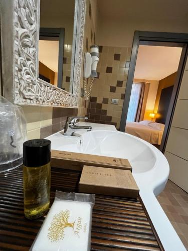 a bathroom with a sink and a mirror at Hotel Fortyfive in Chivasso