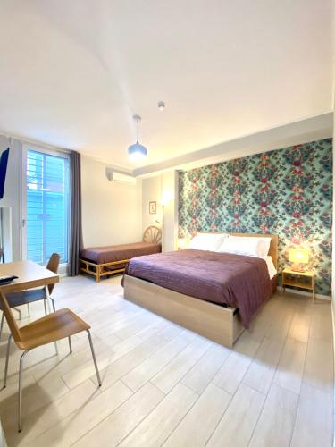 a bedroom with a large bed with a large floral wall at Sunny Beach Bari in Bari