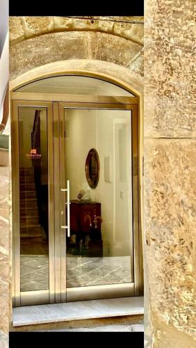 an entrance to a building with a glass door at Plaza Suites in Piazza Armerina