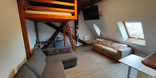 a living room with a couch and a loft at Appartement château Uriage-Chamrousse in Saint-Martin-dʼUriage