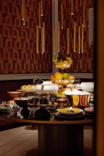 a table filled with plates and bowls of food at Mandarin Oriental Savoy, Zurich in Zurich