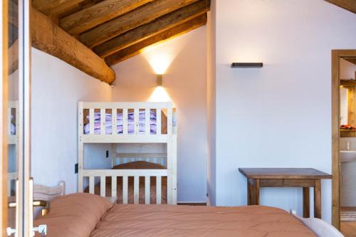 a bedroom with a bed and a wooden ceiling at Chalet Burrino in Frabosa Soprana
