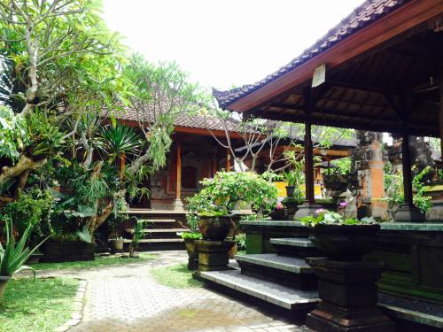 a house with a bunch of plants in front of it at Wina Ubud B&B in Ubud