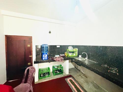 a bathroom with a counter with a sink and a sink at Long Beach Homestay in Tangalle
