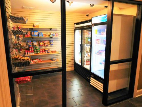 a refrigerator with food inside of a store at Wyndham Garden Greensboro in Greensboro
