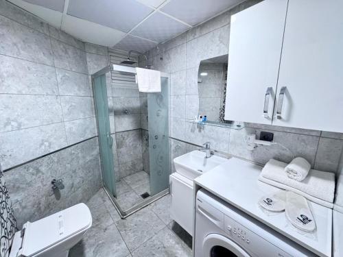 a bathroom with a sink and a toilet and a shower at Ege Suit in Buca