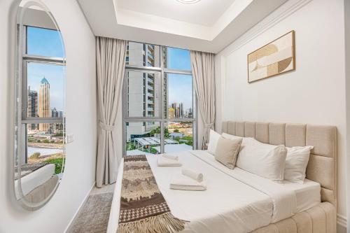 a bedroom with a bed and a large window at Lux Apartments in BusinessBay, Canal views, Great Location in Dubai