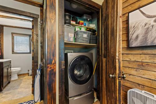 a laundry room with a washer and dryer at Knotty By Nature- Pet Friendly, Firepit, 150 Acres in Campton