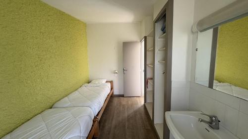 a room with a bed and a tub and a sink at VVF Cotentin Îles anglo-normandes in Portbail