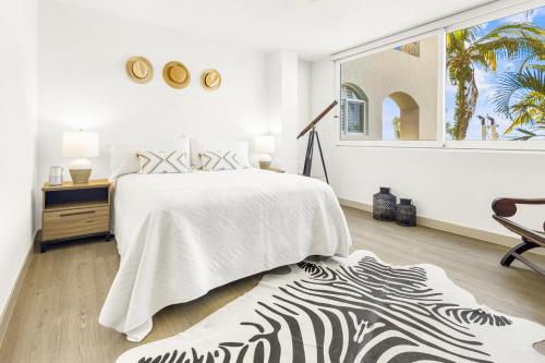 a bedroom with a bed and a zebra print rug at The OceanFront Private Residence in La Paz