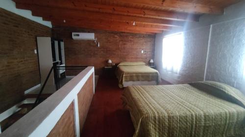 a room with two beds and a window at Dúplex para 4 San Luis in Barranca Colorada