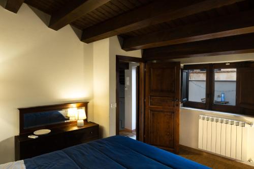 a bedroom with a blue bed and a window at Appartamento con Vista sul Mare a Termini Imerese - Eden Holiday Home in Termini Imerese