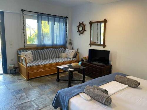 a living room with two beds and a couch at Charming Spetses Studio with Outdoor Space in Spetses