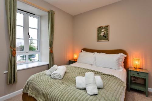 a bedroom with a bed with towels on it at Finest Retreats - The Kiln in Bamburgh