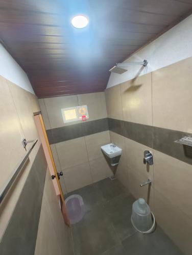a small bathroom with a sink and a toilet at Hang on in Anachal