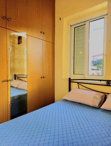 a bedroom with a bed and a window and a bed sqor at Mary's apartment Elaia 3 in Elia Laconias