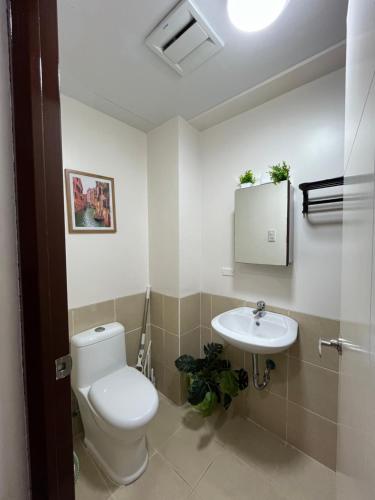 a bathroom with a toilet and a sink at Celeste Stays- Celandine in Sampong