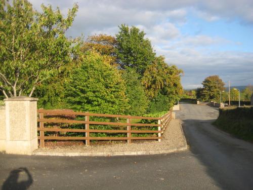 a wooden fence on the side of a road at Drumspittal House Guest Accomodation in Armagh