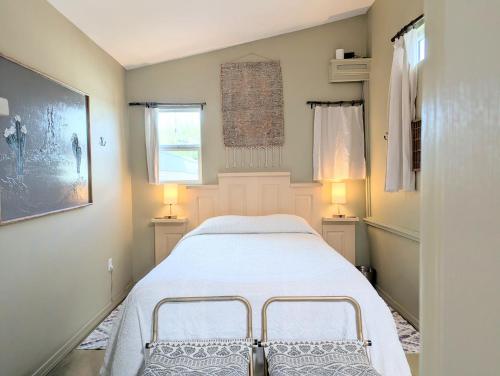 a small bedroom with a bed and two lamps at Early Birds in Tucson