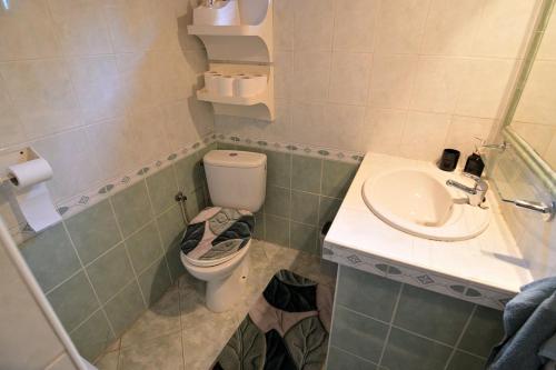 a bathroom with a toilet and a sink at Andrea Chata in Štrba