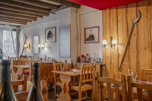 a dining room with wooden tables and chairs at Hôtel du Centre in Villard-de-Lans